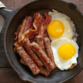 bacon sausage eggs in frying pan